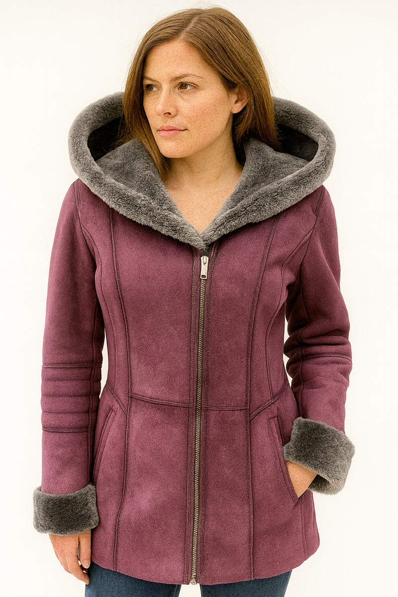 Woman wearing a purple coat with gray fur trim on a white background